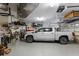 Spacious garage featuring a pickup truck, overhead storage, and epoxy flooring at 7211 Pasadena Gln, Lakewood Ranch, FL 34202