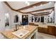 A well-lit kitchen features wooden ceiling beams and an island with a farmhouse sink and granite countertop at 7211 Pasadena Gln, Lakewood Ranch, FL 34202