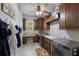 Functional laundry room with ample cabinet space, utility sink, washer, and dryer at 7211 Pasadena Gln, Lakewood Ranch, FL 34202