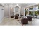 Comfortable living room features a fireplace, and seamless indoor-outdoor flow to the pool at 7211 Pasadena Gln, Lakewood Ranch, FL 34202