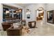 Spacious living room featuring a fireplace, elegant columns and comfortable seating, extending to the outdoor living area at 7211 Pasadena Gln, Lakewood Ranch, FL 34202
