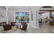 Inviting living room with a cozy fireplace, comfortable seating, and open access to the pool area at 7211 Pasadena Gln, Lakewood Ranch, FL 34202