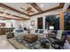 Bright living room features decorative ceiling fan, archways, and opens to the lanai with pool view at 7211 Pasadena Gln, Lakewood Ranch, FL 34202