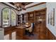 Wood-paneled office with a built-in bookshelf, hardwood floors, and a large window at 7211 Pasadena Gln, Lakewood Ranch, FL 34202