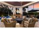 Inviting outdoor space with stone fireplace, cozy seating, and poolside views, perfect for relaxing or entertaining at 7211 Pasadena Gln, Lakewood Ranch, FL 34202