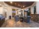 Stylish outdoor living area with a built-in grill, stone fireplace, and access to the home's interior at 7211 Pasadena Gln, Lakewood Ranch, FL 34202