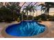 Screened pool area with brick pavers, spa, and tropical foliage creates a serene retreat at 7211 Pasadena Gln, Lakewood Ranch, FL 34202
