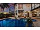 Screened pool area with brick pavers, spa, and view of the home's exterior and landscaping at 7211 Pasadena Gln, Lakewood Ranch, FL 34202