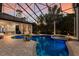 Screened pool area with brick pavers, spa, and outdoor bar area offers a relaxing outdoor experience at 7211 Pasadena Gln, Lakewood Ranch, FL 34202