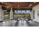 Bright sunroom featuring tile flooring, ceiling fans, and expansive windows with a stunning view of the lake and lush landscape at 7211 Pasadena Gln, Lakewood Ranch, FL 34202