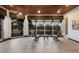 Cozy sunroom with tile floors, ceiling fans, and large windows offering scenic views of the lake and surrounding greenery at 7211 Pasadena Gln, Lakewood Ranch, FL 34202