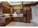 A well-equipped wet bar with custom cabinetry, a wine cooler, granite countertops, and modern appliances at 7211 Pasadena Gln, Lakewood Ranch, FL 34202