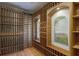 Custom wine cellar featuring ample storage racks and a charming mural adding elegance to the space at 7211 Pasadena Gln, Lakewood Ranch, FL 34202