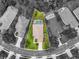 Aerial view of a home with a pool, surrounded by lush greenery and neighboring houses at 7424 Sea Island Ln, Bradenton, FL 34201