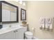 Bathroom features a white vanity with a vessel sink, with framed art and fresh white towels at 7424 Sea Island Ln, Bradenton, FL 34201