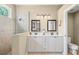 Bathroom featuring double sink vanity with marble countertop and a glass enclosed shower at 7424 Sea Island Ln, Bradenton, FL 34201