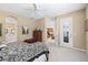 Bright bedroom with neutral walls, ceiling fan, and doorway leading to the ensuite bathroom at 7424 Sea Island Ln, Bradenton, FL 34201