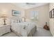 Cozy bedroom with a queen bed, plantation shutters, and neutral tones creates a relaxing retreat at 7424 Sea Island Ln, Bradenton, FL 34201