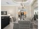 Elegant dining area with a glass table, stylish chairs, and views into the living room and kitchen at 7424 Sea Island Ln, Bradenton, FL 34201