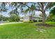 Charming home exterior with a long driveway, well-maintained lawn, and mature trees at 7424 Sea Island Ln, Bradenton, FL 34201