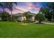 Charming single-story home featuring a well-manicured lawn, mature landscaping, and inviting curb appeal at 7424 Sea Island Ln, Bradenton, FL 34201