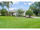 Charming single-story home with lush green lawn, mature landscaping, and a well-manicured front yard at 7424 Sea Island Ln, Bradenton, FL 34201