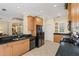 Spacious kitchen featuring black appliances, granite counters, wood cabinets, and tile flooring at 7424 Sea Island Ln, Bradenton, FL 34201