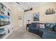 Living room featuring a comfortable couch, nautical decor, carpet flooring, and a built-in bookcase at 7424 Sea Island Ln, Bradenton, FL 34201