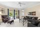 Comfortable living room featuring a view of the pool area, plush seating, and modern decor at 7424 Sea Island Ln, Bradenton, FL 34201