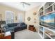 Cozy living room featuring a navy couch, nautical decor, carpet flooring, and built-in shelving with a television at 7424 Sea Island Ln, Bradenton, FL 34201