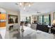 Open-concept living space with stylish furnishings, neutral colors, and seamless flow into dining and kitchen areas at 7424 Sea Island Ln, Bradenton, FL 34201