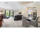 Spacious living room featuring a view of the screened-in pool, modern furniture, and neutral decor at 7424 Sea Island Ln, Bradenton, FL 34201