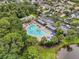Aerial view of a community pool and cabana area surrounded by lush trees and well-maintained grounds at 7424 Sea Island Ln, Bradenton, FL 34201