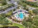 Aerial shot showcases a community pool area with lounge seating, a playground, and manicured landscaping at 7424 Sea Island Ln, Bradenton, FL 34201