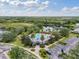 Aerial view of a community pool and lounge area surrounded by palm trees and a parking lot at 7424 Sea Island Ln, Bradenton, FL 34201