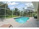 Private screened-in pool surrounded by a brick patio and lush greenery at 7424 Sea Island Ln, Bradenton, FL 34201