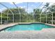 Relaxing screened-in pool with brick paver surround, offering a private outdoor space at 7424 Sea Island Ln, Bradenton, FL 34201