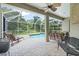 Screened-in pool with brick pavers, lounge chairs, and a lush green backdrop at 7424 Sea Island Ln, Bradenton, FL 34201