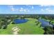 Scenic aerial view of lush green golf course, tranquil lakes, and beautiful landscapes providing a serene retreat at 7717 Us Open Loop, Lakewood Ranch, FL 34202