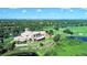 Aerial view of a golf course community featuring lush greenery, lakes and luxury homes at 7717 Us Open Loop, Lakewood Ranch, FL 34202