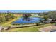 Breathtaking aerial view of the pond, golf course, and lush landscaping at 7717 Us Open Loop, Lakewood Ranch, FL 34202