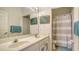 Bathroom with a double sink vanity, large mirror, and shower-tub combination at 7717 Us Open Loop, Lakewood Ranch, FL 34202