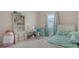 Bedroom with a large window, desk, built-in shelving, and neutral paint at 7717 Us Open Loop, Lakewood Ranch, FL 34202