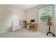 Bright bedroom with a large window and space for a desk or vanity at 7717 Us Open Loop, Lakewood Ranch, FL 34202