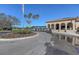 Welcoming clubhouse featuring a roundabout and nearby golf carts, set against a backdrop of palm trees at 7717 Us Open Loop, Lakewood Ranch, FL 34202