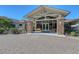 Inviting clubhouse entrance featuring stone columns, glass doors, and a brick walkway, creating a welcoming atmosphere for visitors at 7717 Us Open Loop, Lakewood Ranch, FL 34202