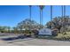 The Legacy Golf Club entrance is framed by palm trees, landscaping, and a sign in front of lush greenery at 7717 Us Open Loop, Lakewood Ranch, FL 34202