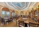 Elegant dining room featuring custom ceiling details, an expansive layout, and lots of seating at 7717 Us Open Loop, Lakewood Ranch, FL 34202