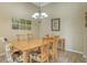 Light-filled dining room features wood flooring, chandelier lighting, and unique floral chairs at 7717 Us Open Loop, Lakewood Ranch, FL 34202