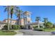 Striking building features grand architecture, a covered entrance, and meticulously manicured landscaping at 7717 Us Open Loop, Lakewood Ranch, FL 34202